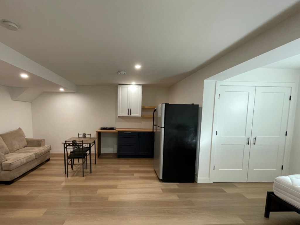 A photo shows a newly built studio basement suite.