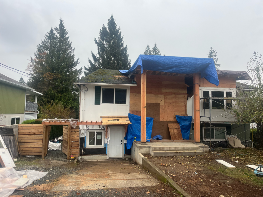 A large front entry way addition is half-built.